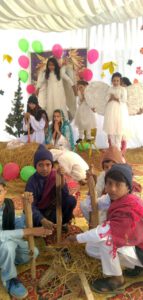 Picture of the nativity scene with children dresses as shepherds, angels, St Mary and St Joseph